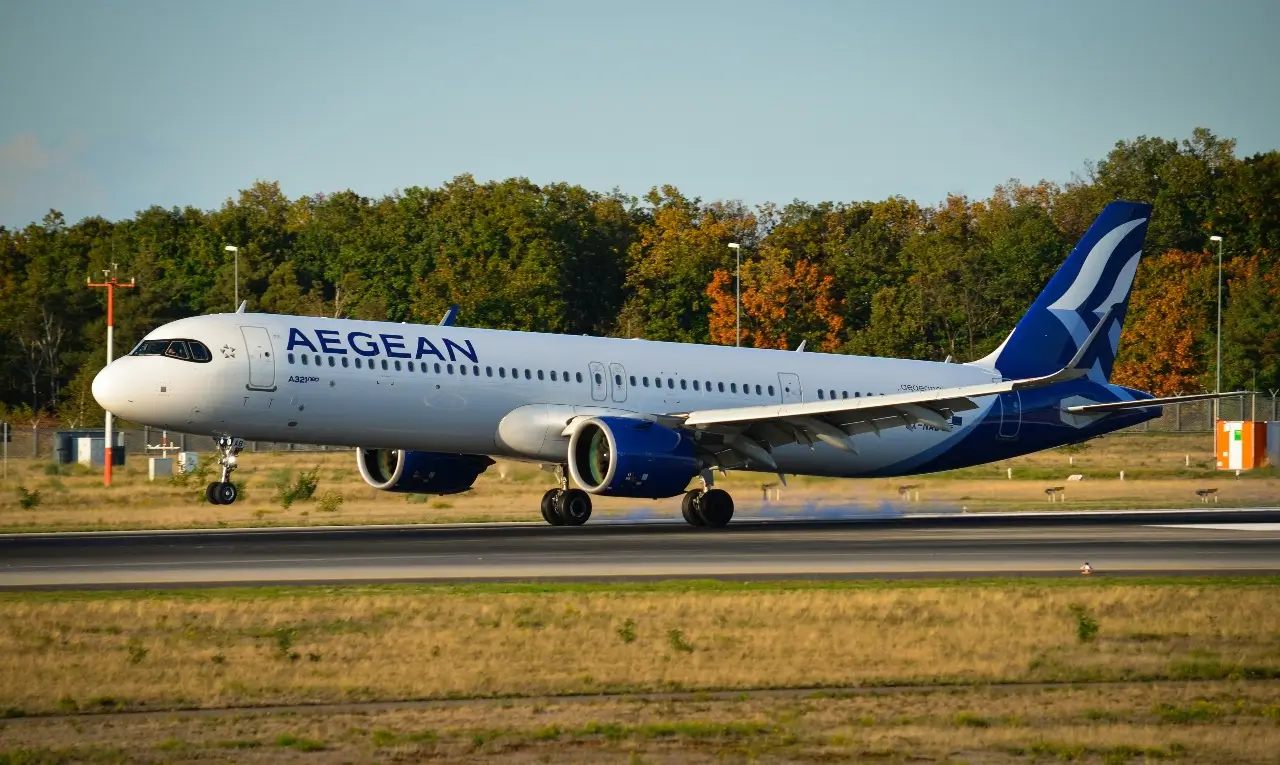 A white and blue Aegean Airlines plane immediately after landing on the runway