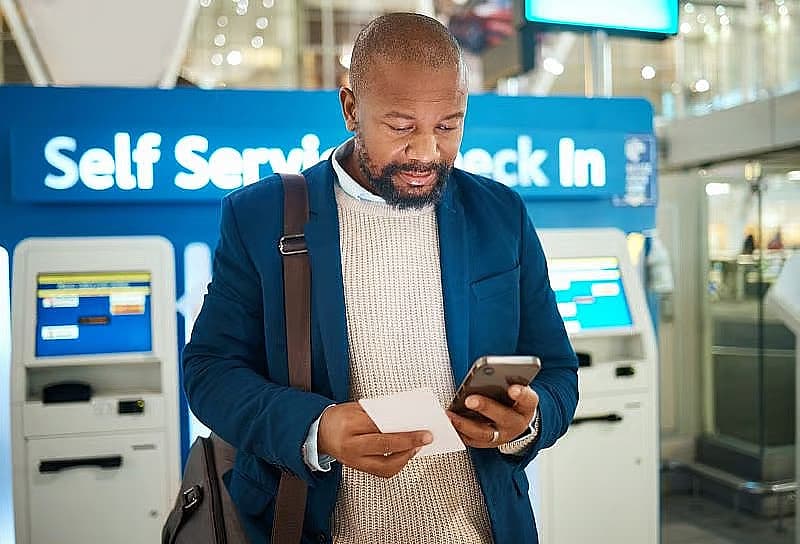 Man checking his phone at the airport