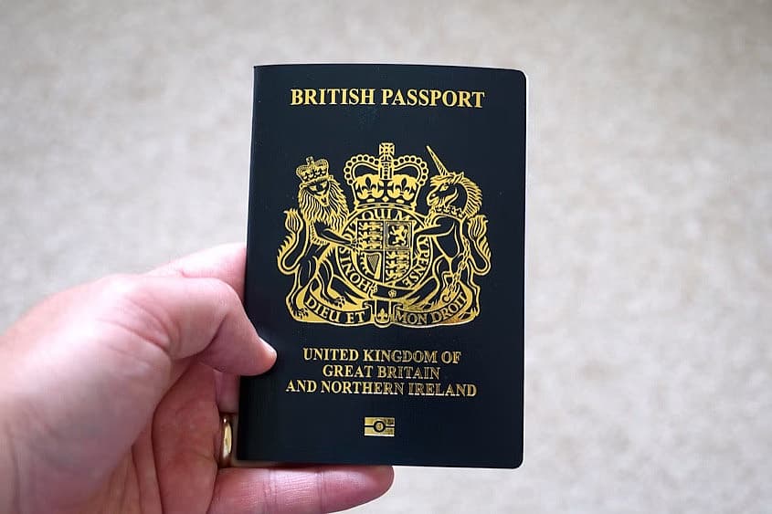 Hand holding a UK passport