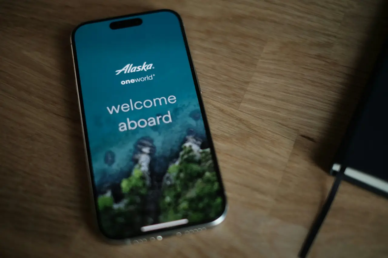 A phone displaying the start page of the Alaska Airlines app