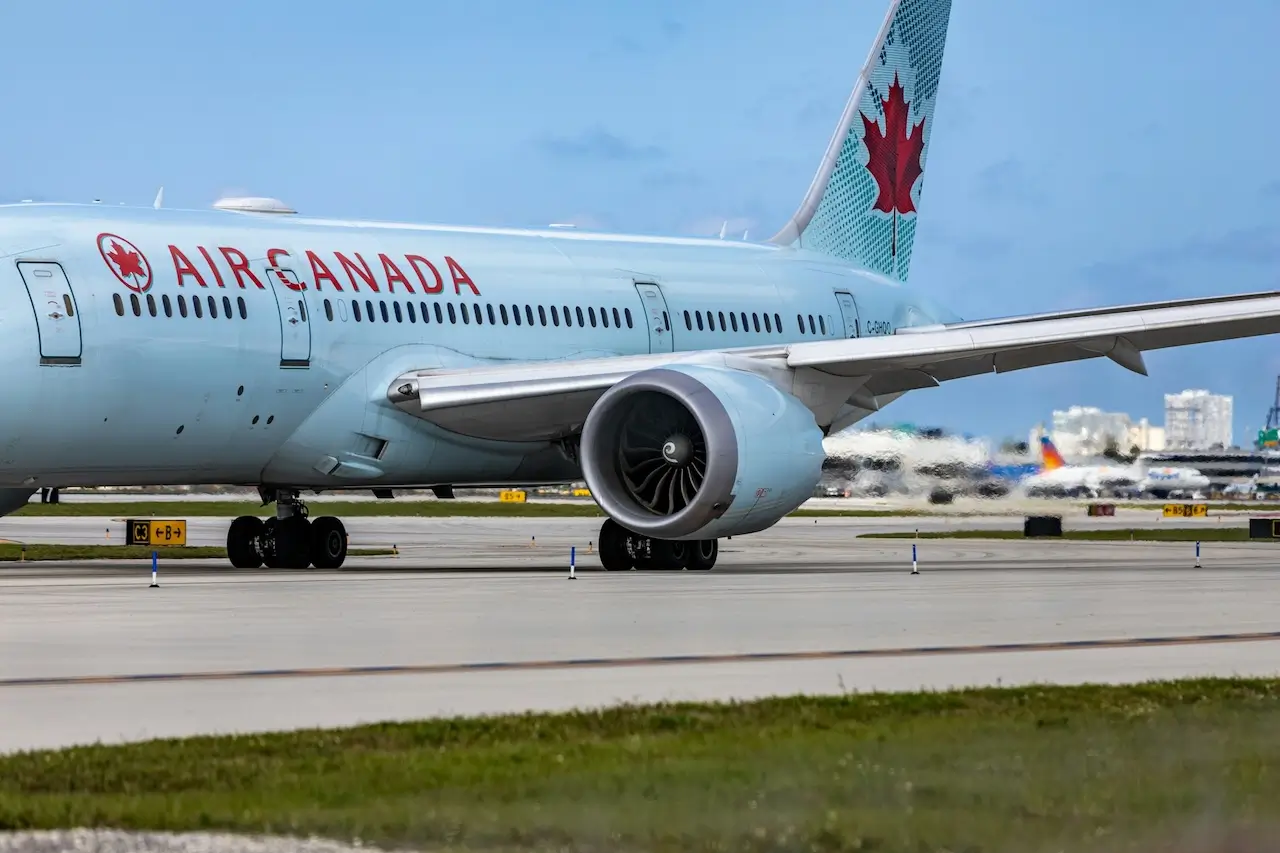 A close-up of a plane on the tarmac clearly showing the Air Canada logo