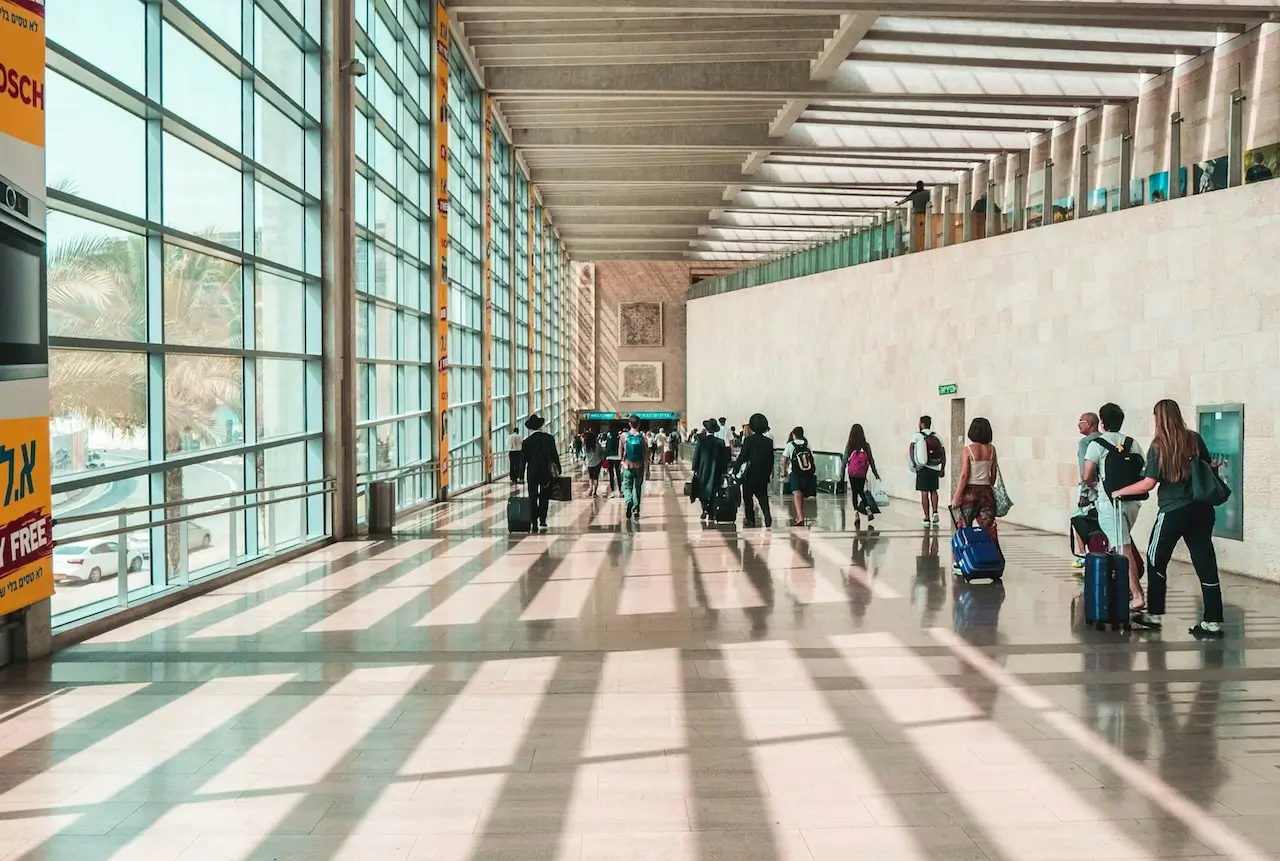 People are walking through Ben Gurion Airport
