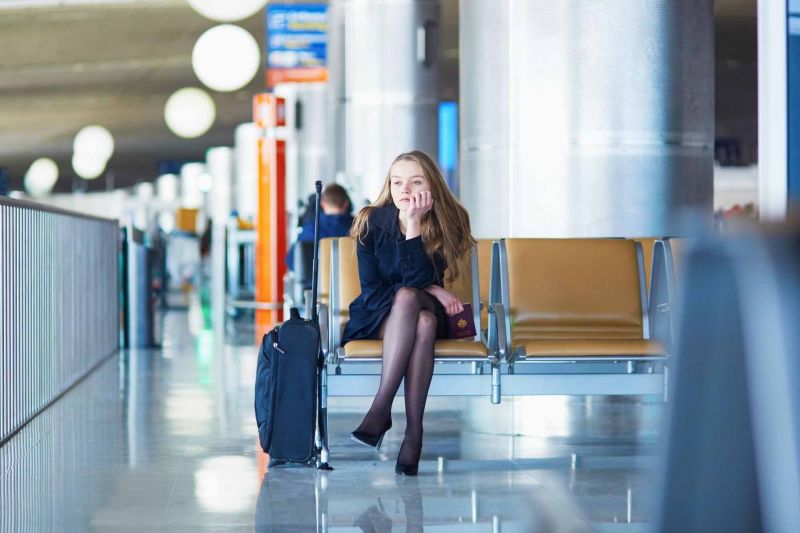 a woman waiting in Paris Charles de Gaulle Aiport CDG after her flight was cancelled