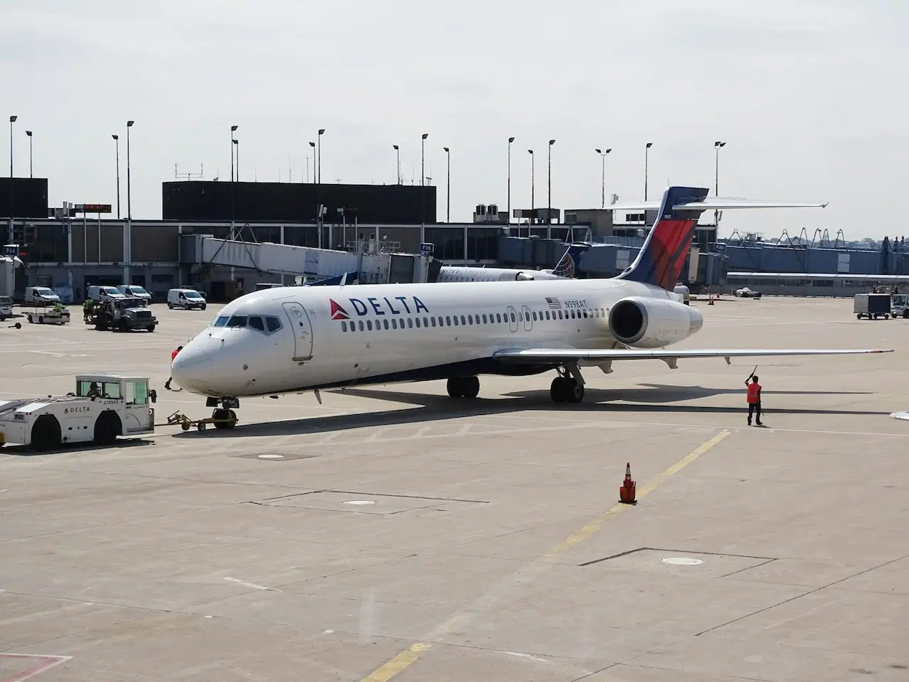 A Delta aircraft is being moved to a new gate