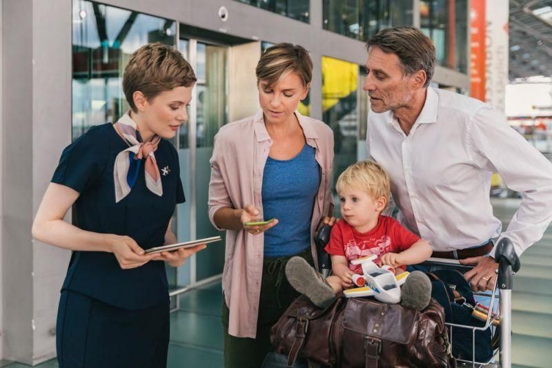 Genrebild över en familj som förbereder sig för att boarda flygplanet