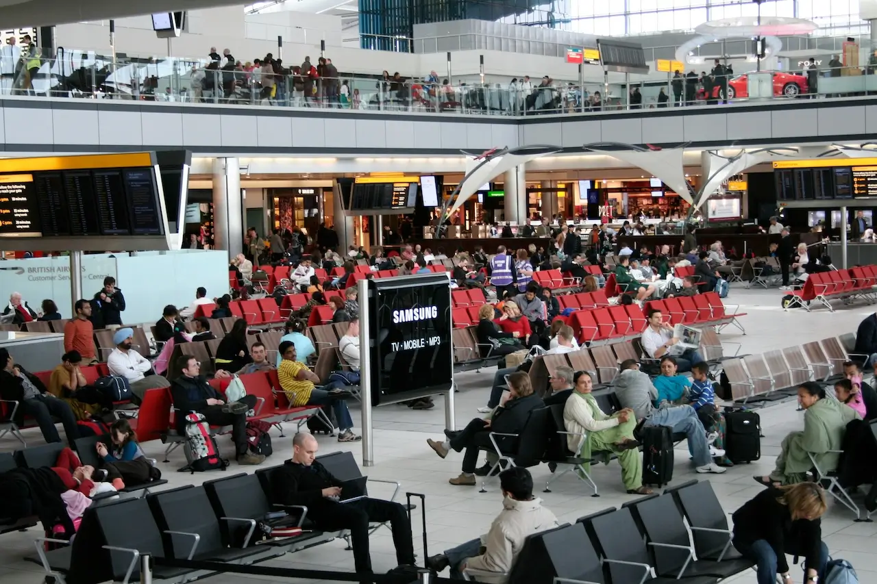 People waiting for a replacement flight at London Heathrow Airport after a RwandAir cancellation