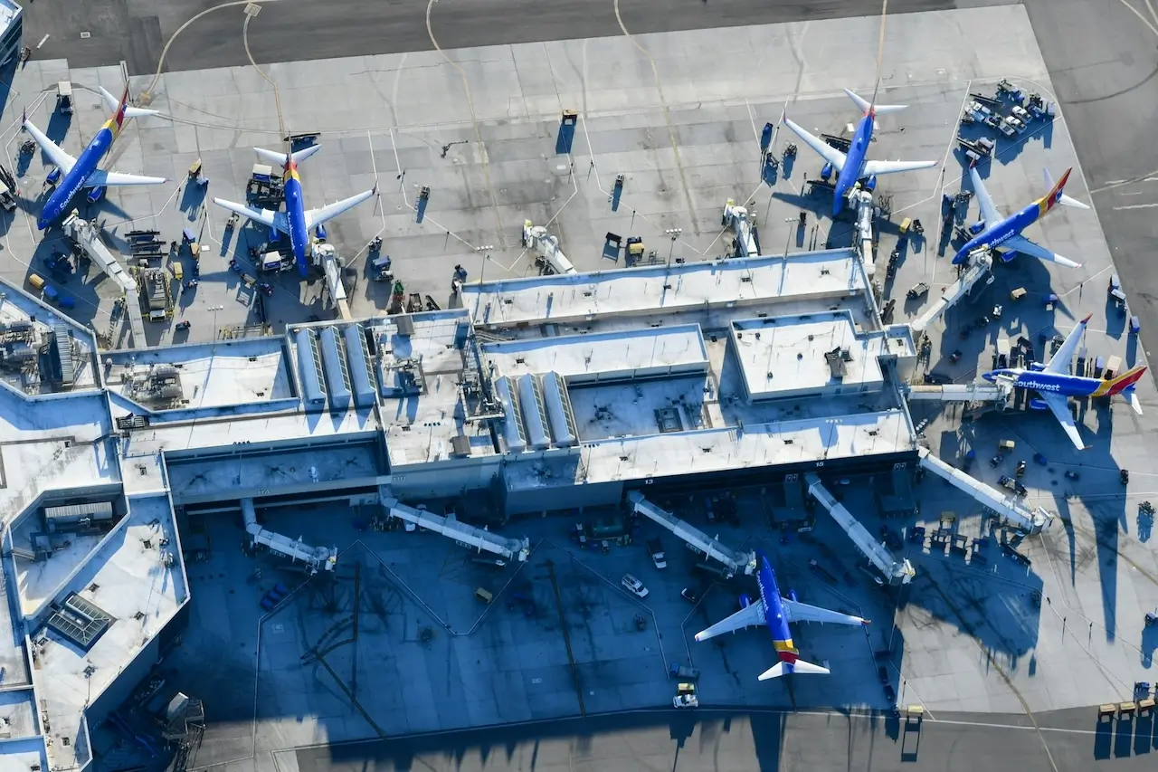 The terminal building at LAX from above, surrounded by planes at the gates
