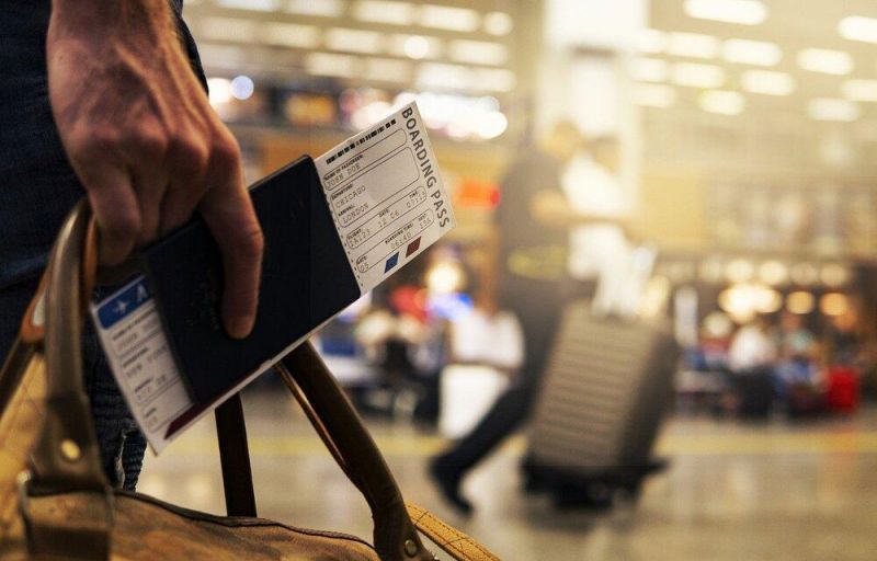 Man holding a boarding pass at the airport