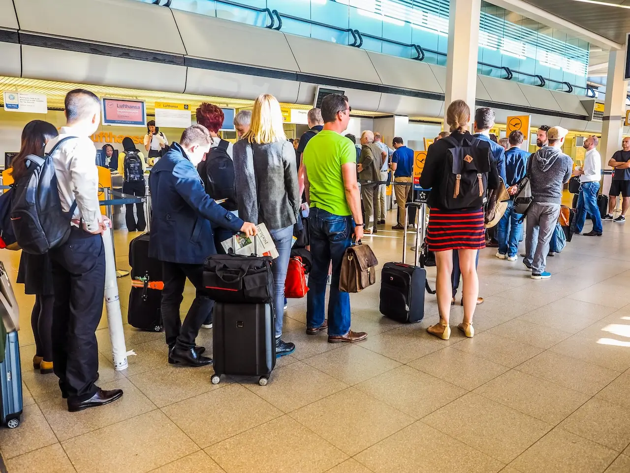 People queue at Tegel airport check-in