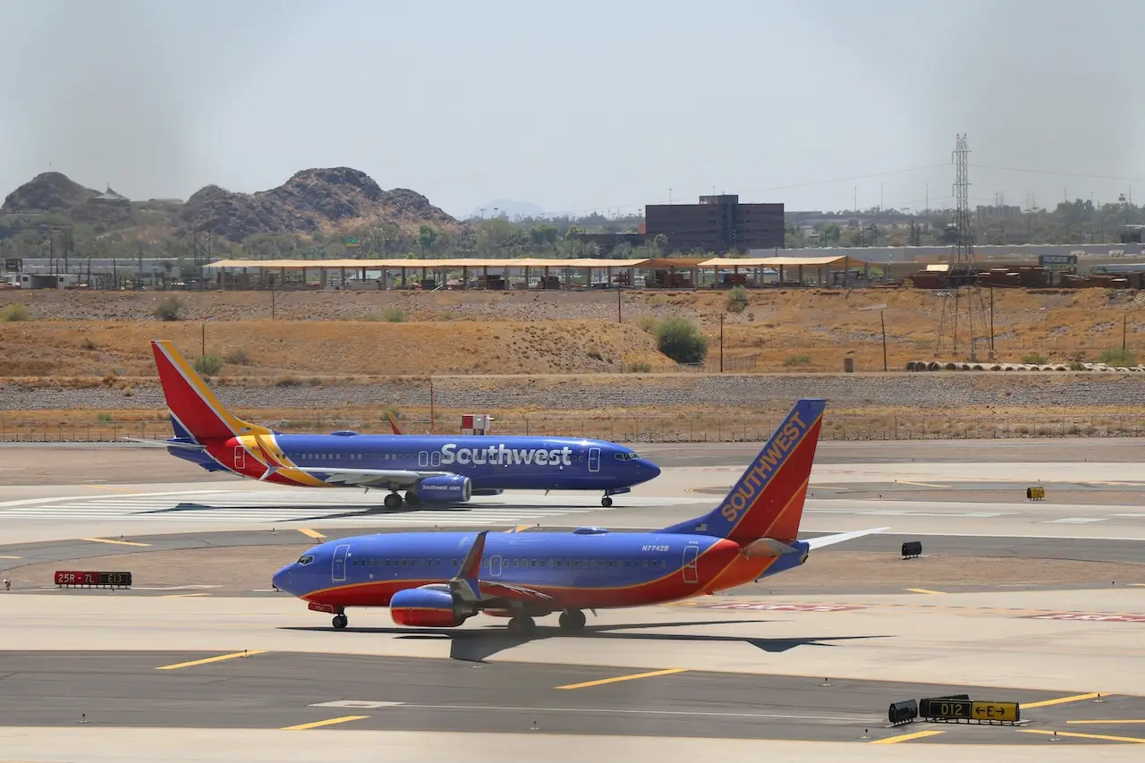 Two Southwest Airlines planes on the tarmac after luggage has been loaded