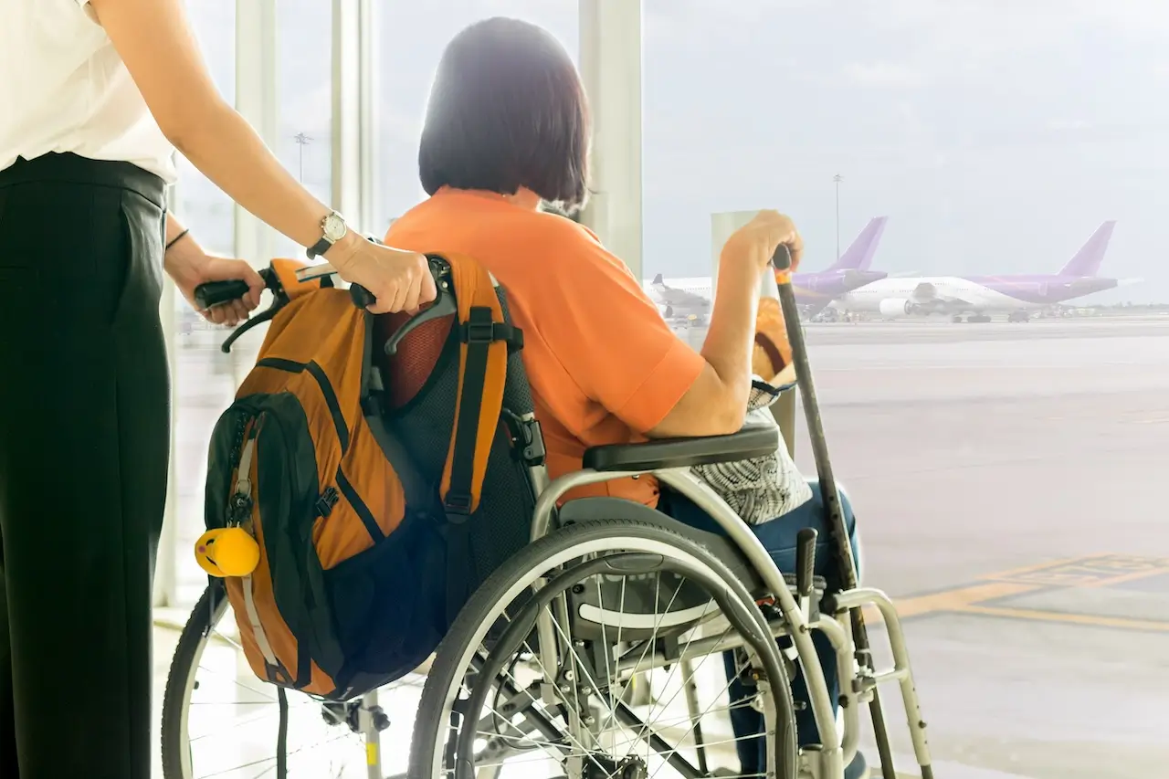 Woman-with-mother-in-wheelchair-waiting-for-boarding