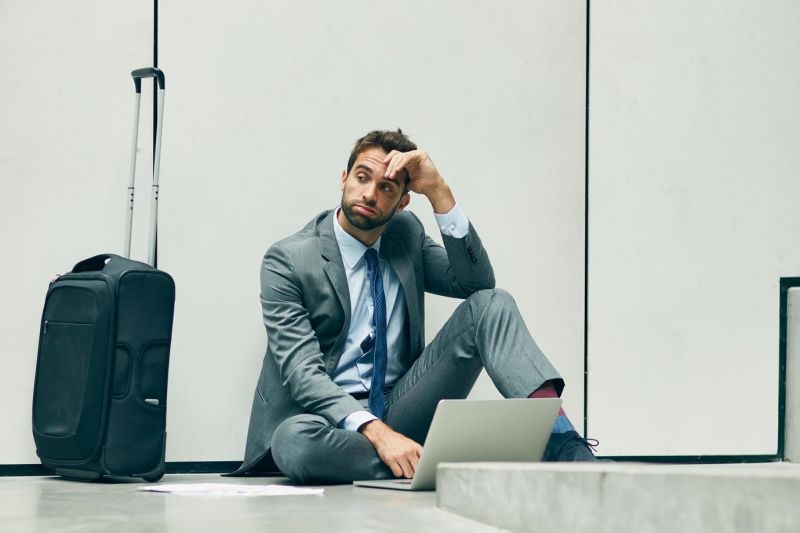 a businessman stuck at the airport because of a flight delay