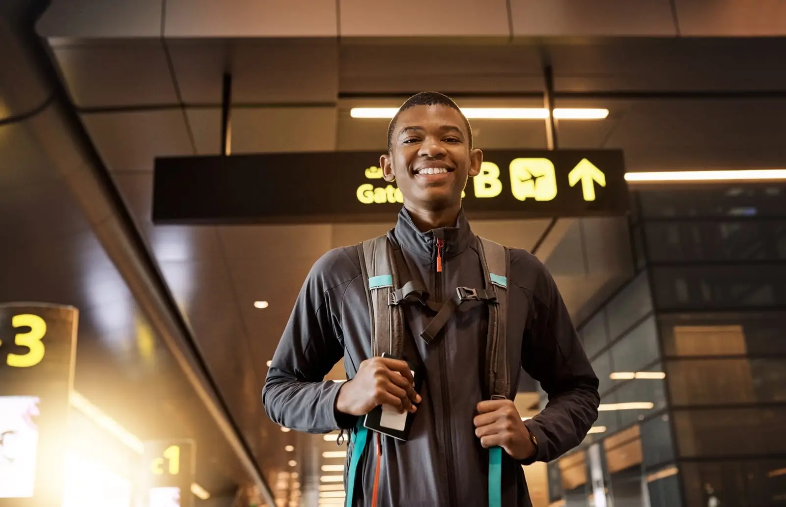 a young man standing in an airport
