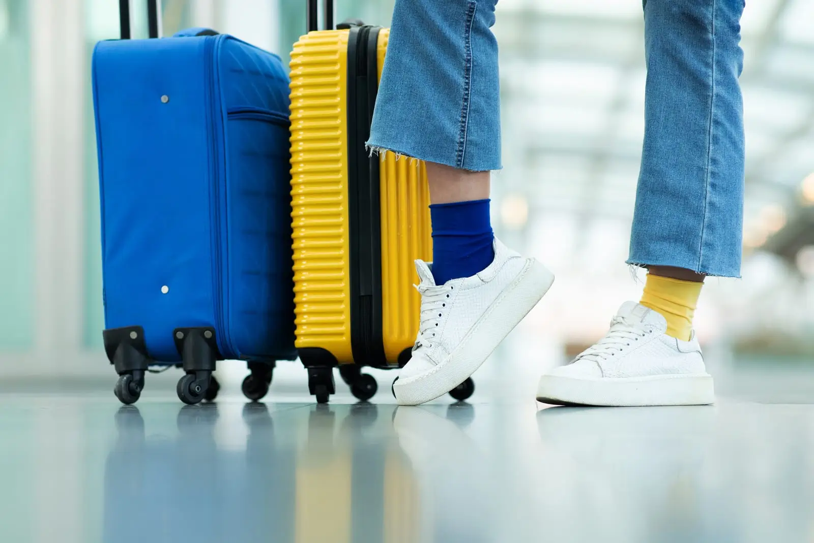blue and yellow travel suitcases at airport
