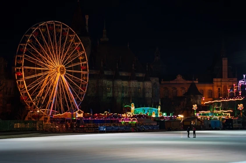 Budapest City Park ice rink with a Ferris wheel and Vajdahunyad Castle at night