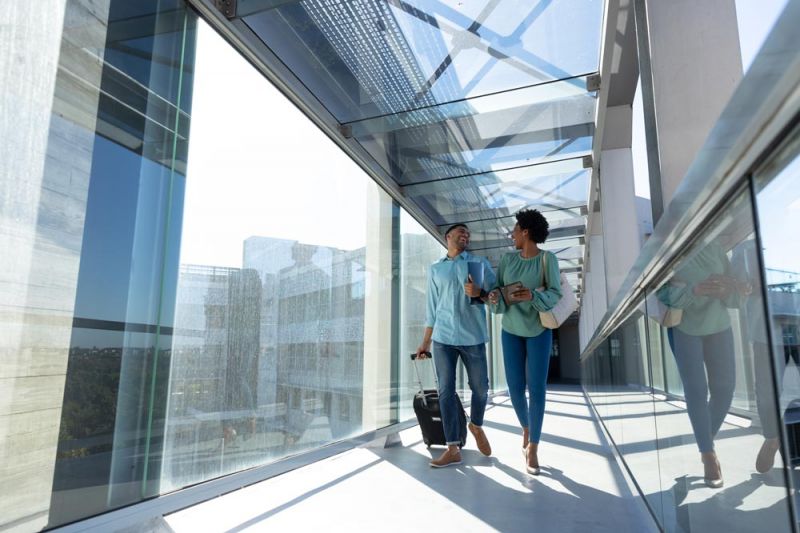 Couple walking through Heathrow after delays of their flights were confirmed