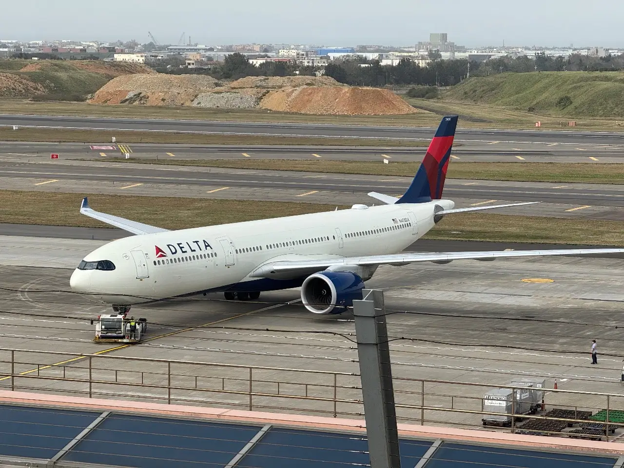 A Delta plane sitting idle at the airport due to a canceled flight