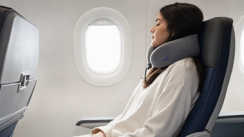 Resen&auml;r som sitter med resekudde p&aring; flygplan