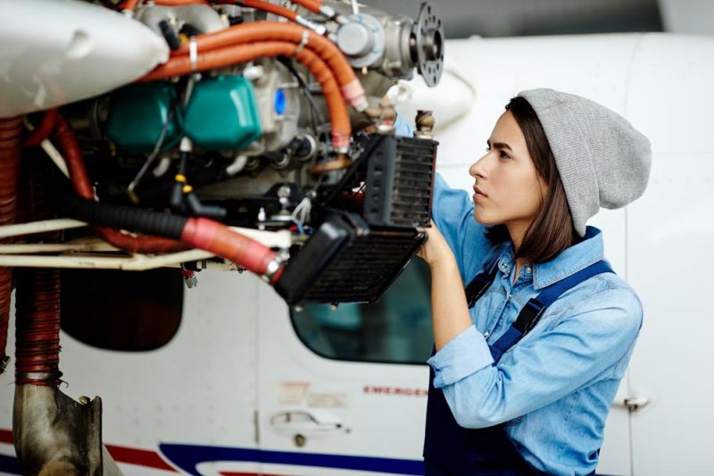 An engineer checks on a delayed flight plane