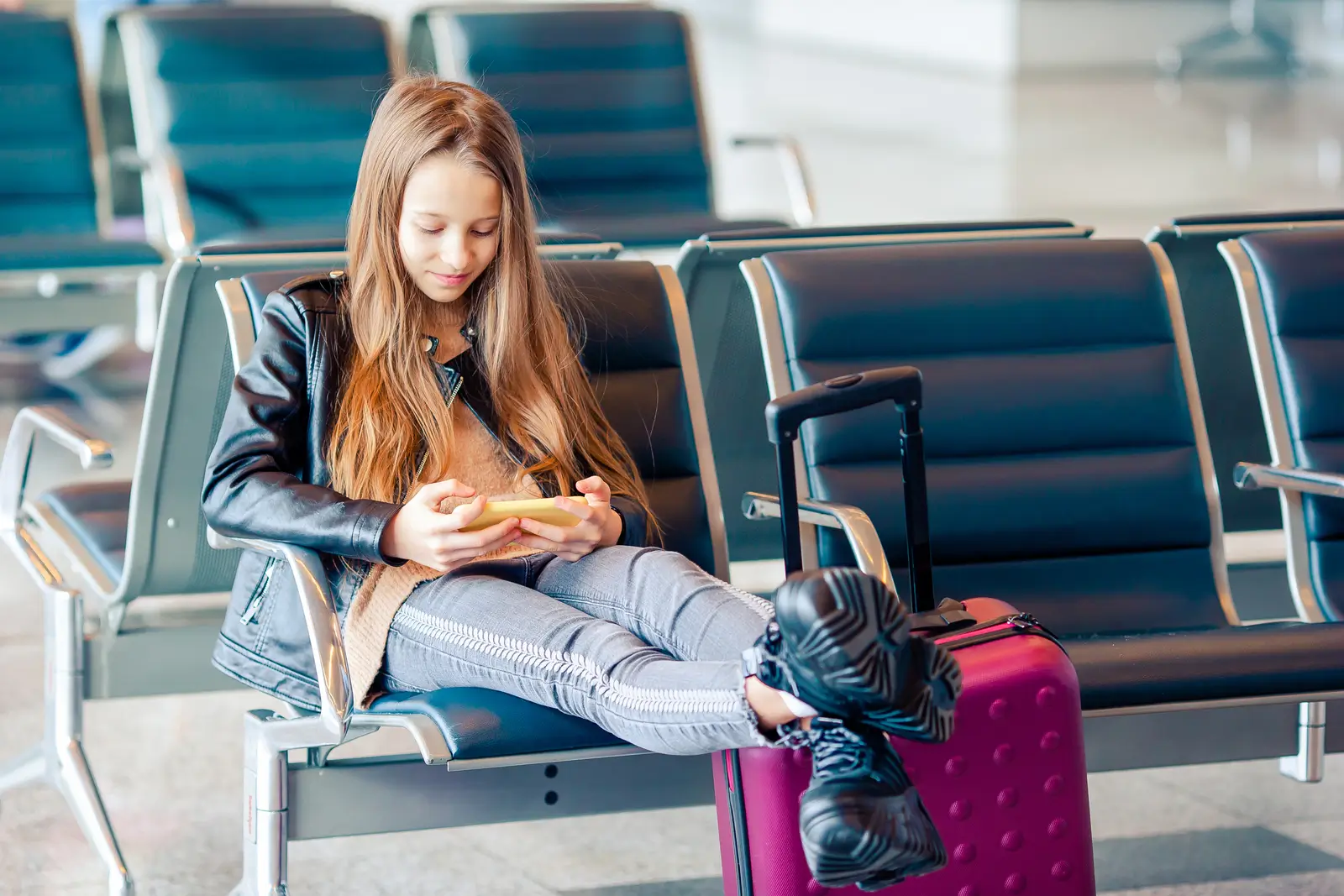 M&auml;dchen am Flughafen in einem gro&szlig;en internationalen Flughafen in der N&auml;he eines Fensters