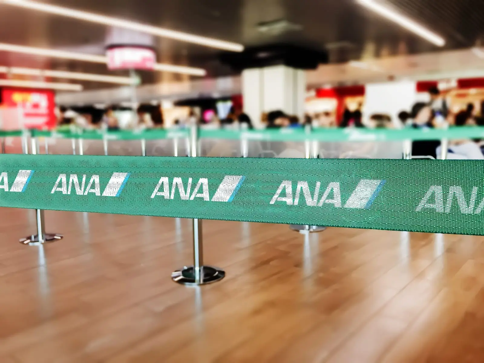 green belt barrier with white ana all nippon airways logo