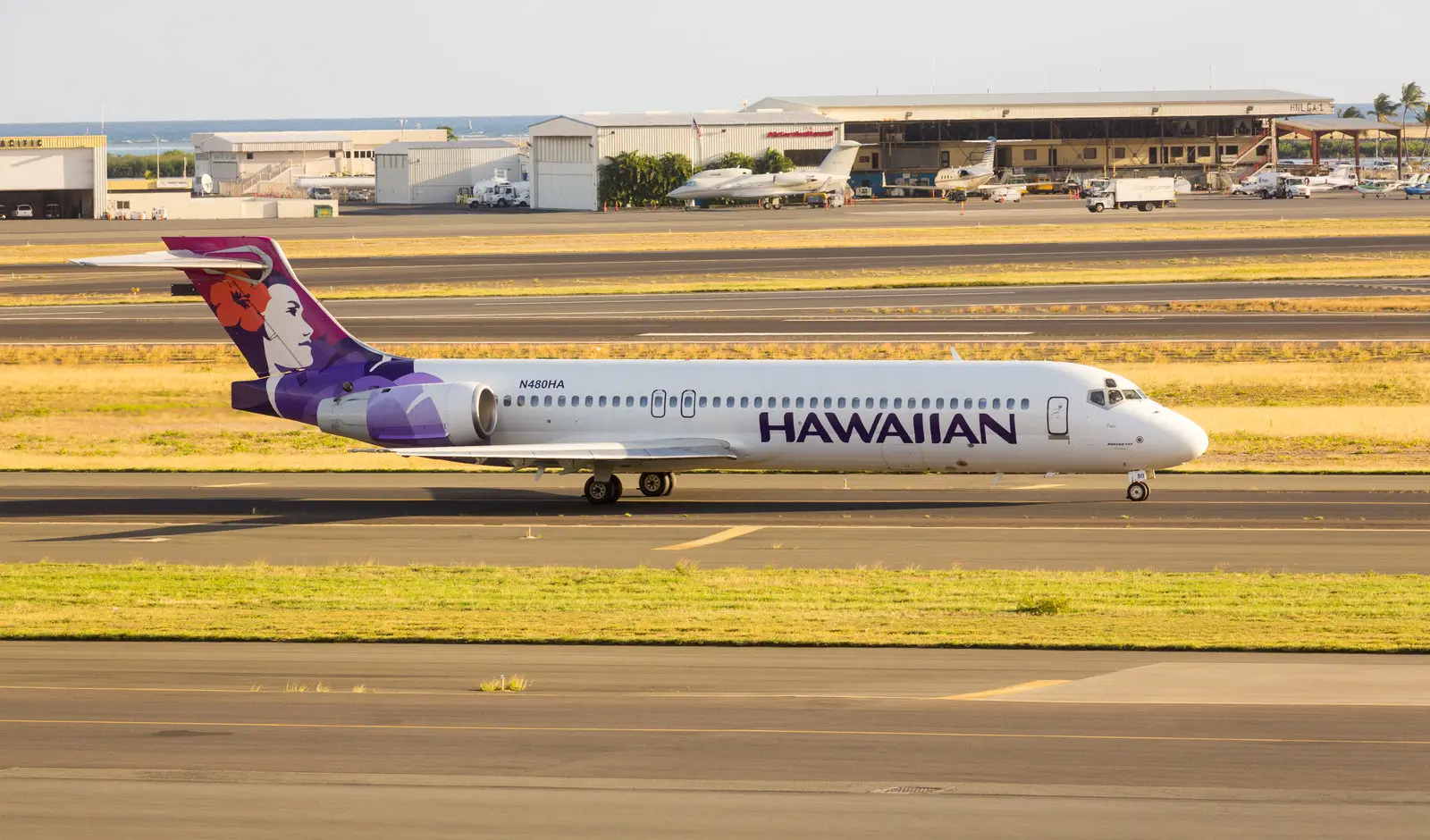 A white Hawaiian Airlines plane at the airport