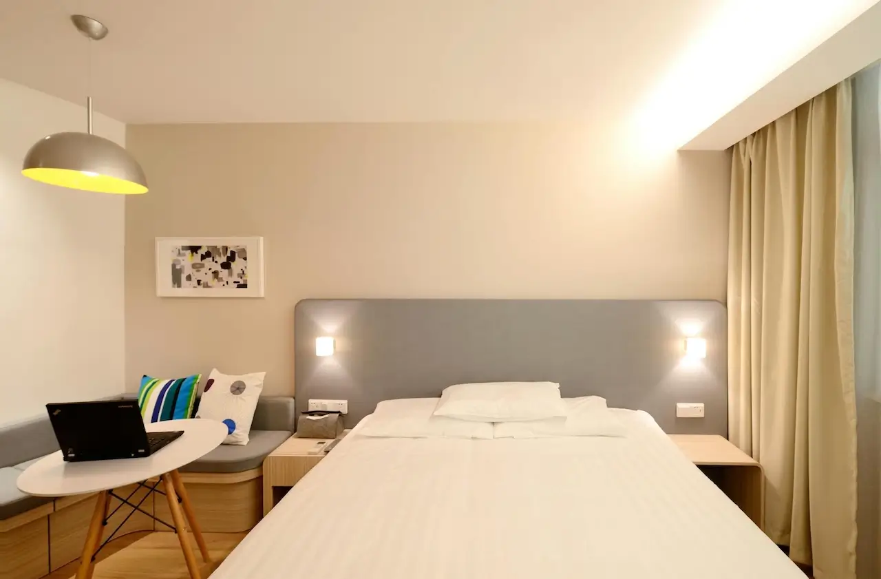 The interior of a typical hotel room with a double bed and a desk