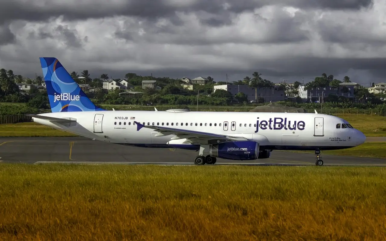 A JetBlue plane at the airport in Barbados, where a big storm is about to roll in and cause flight cancellations