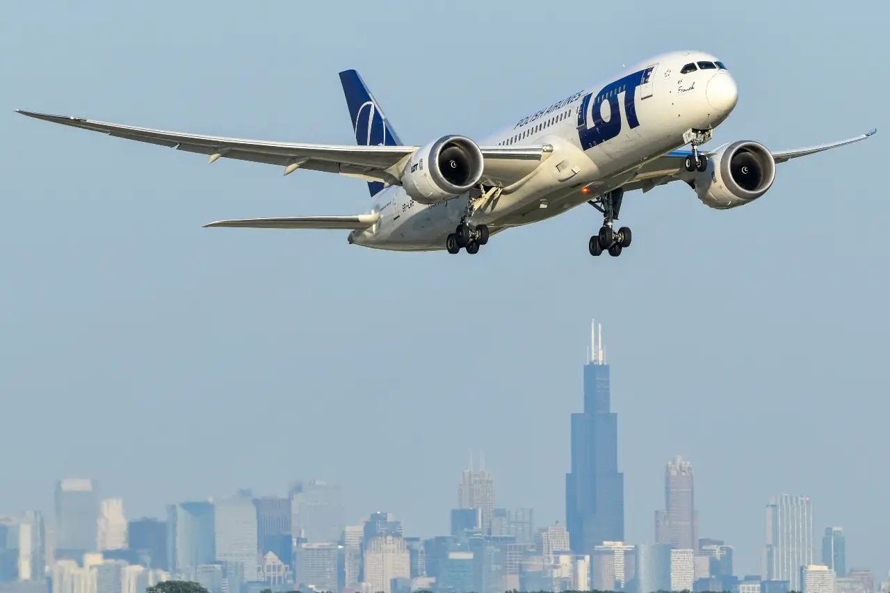 A LOT plane just after take-off with the Chicago skyline in the distance.