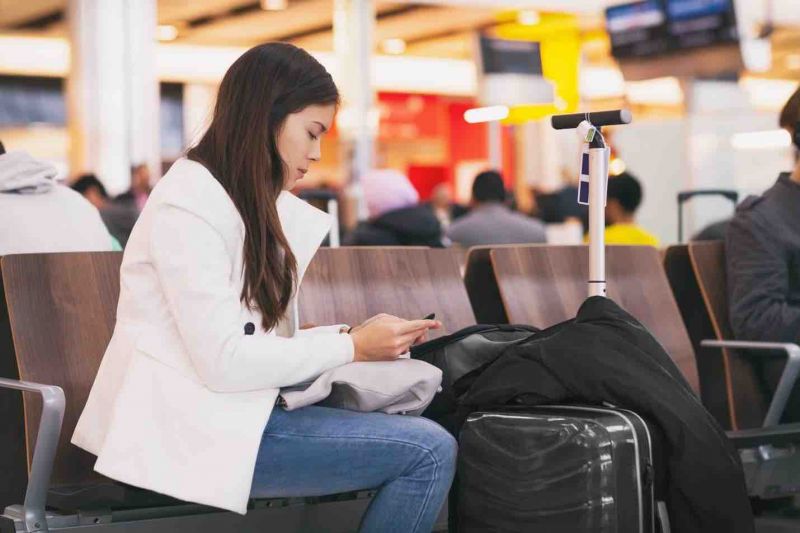 a woman waiting in the airport because her flight was delayed