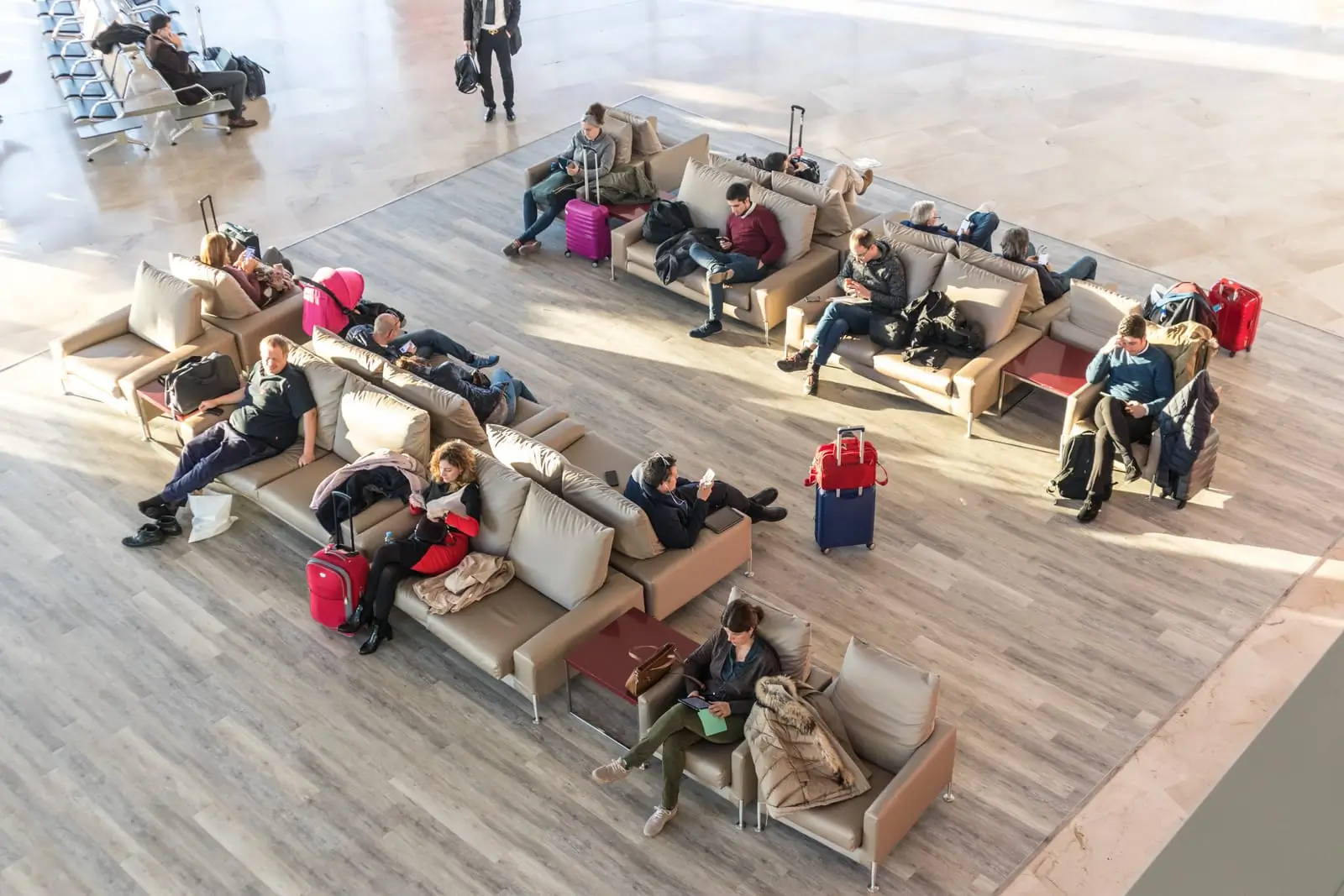 people waiting for their flight at departure terminal
