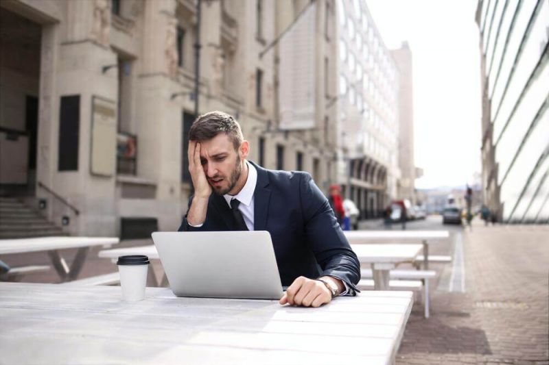 Man is frustrated since he has just received a flight cancellation notice