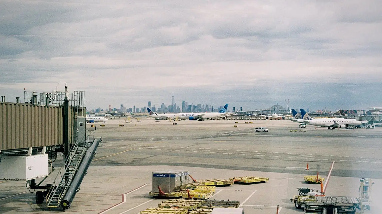 A waiting gate at New York&rsquo;s JFK Airport with the NYC skyline in the distance