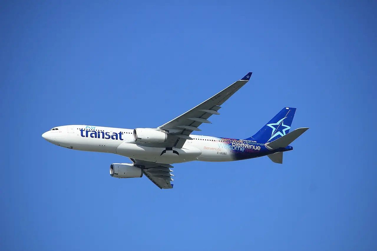 An Air Transat flight in a blue sky &ndash; the company is among the biggest airlines in Canada