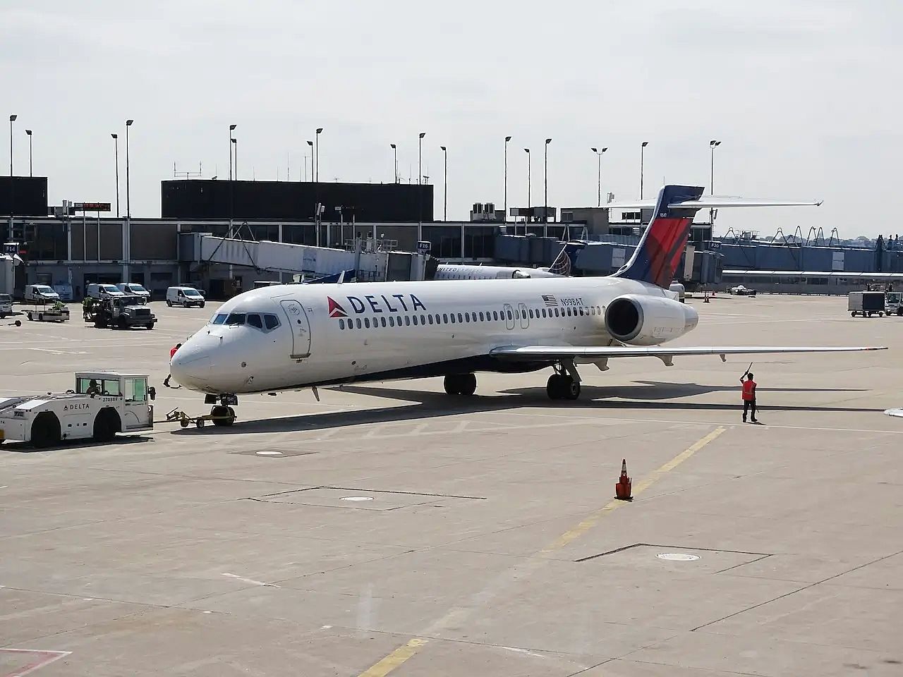 A Delta aircraft is being moved to a new gate