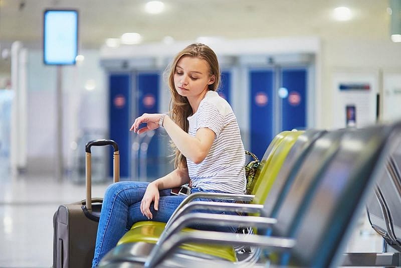 A woman waiting for her delayed ITA Airways flight