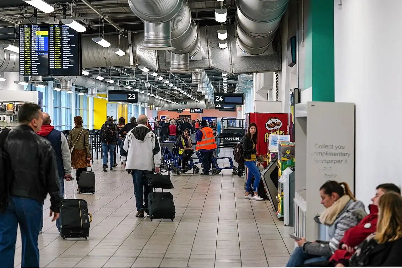Passengers walking through Luton airport in London