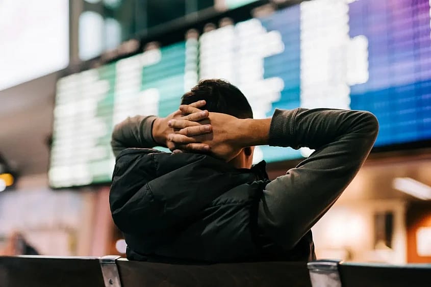 un pasajero mira el tabl&oacute;n de salidas de un aeropuerto