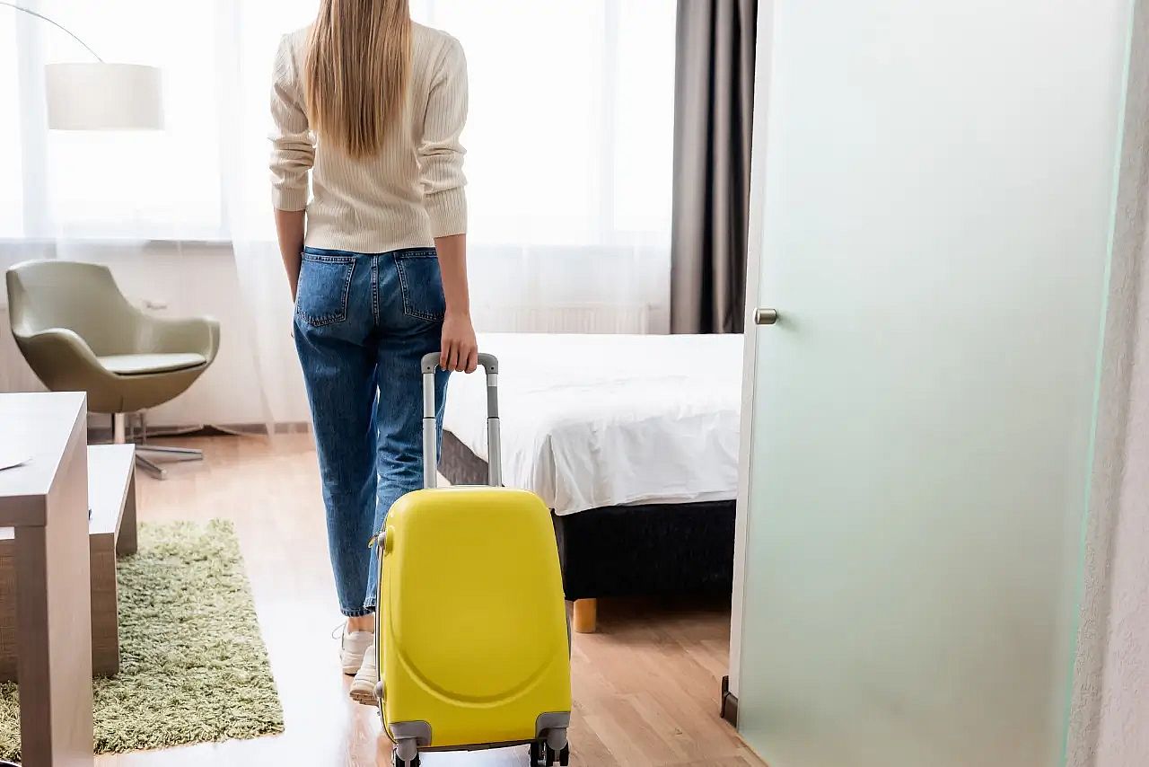 a woman entering a hotel room