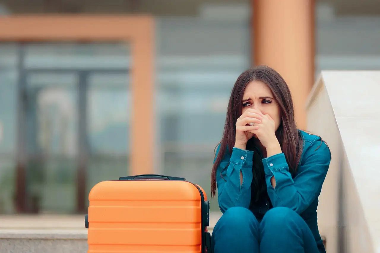 Woman sitting at the airport when Vueling flight delayed