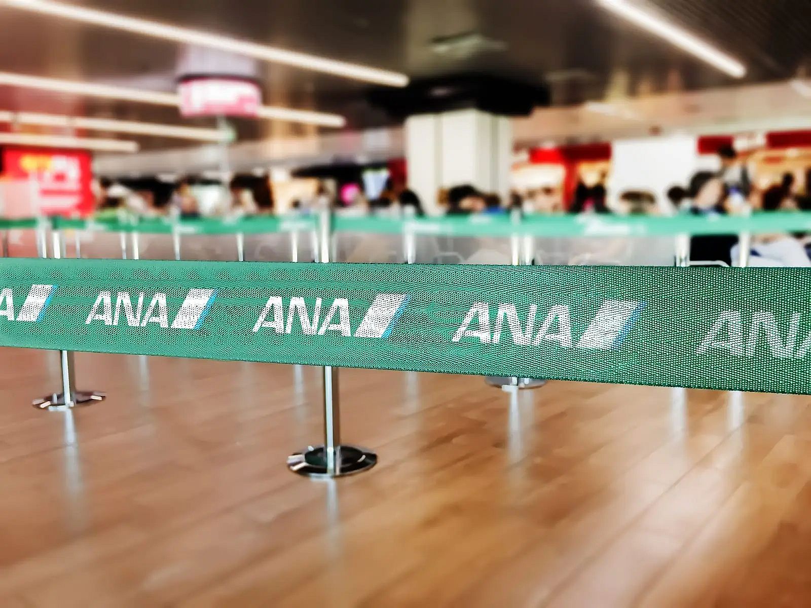 green belt barrier with white ana all nippon airways logo