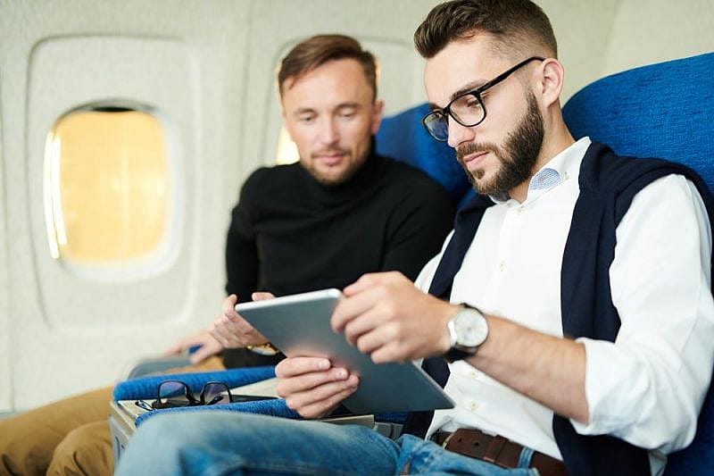 Two men on board talking about TAP Portugal compensation because of delayed flights