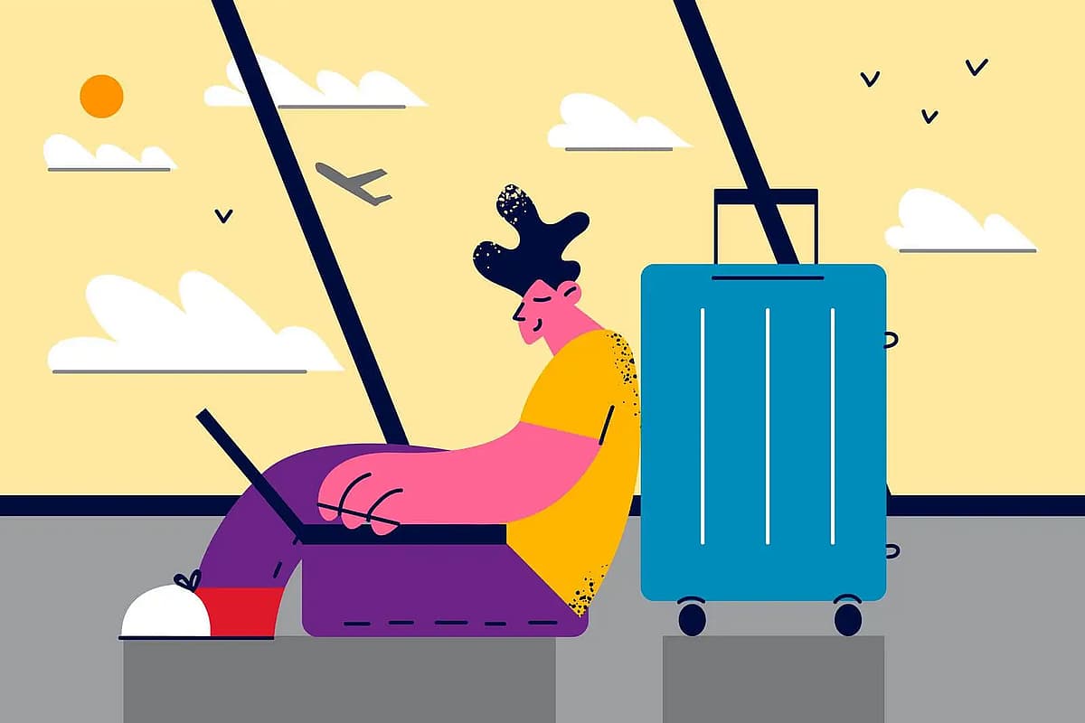 un homme qui travaille sur son ordinateur dans un aeroport
