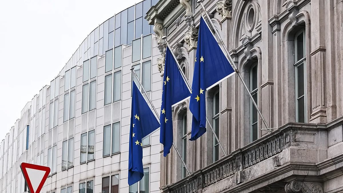 european union flags flying outside building in brussels